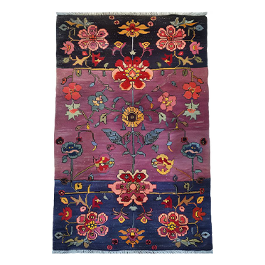 The Dusklight Garden hand-knotted area rug features intricate floral patterns in soft, dusk-inspired hues. Its craftsmanship and luxurious feel add elegance and warmth to any room.