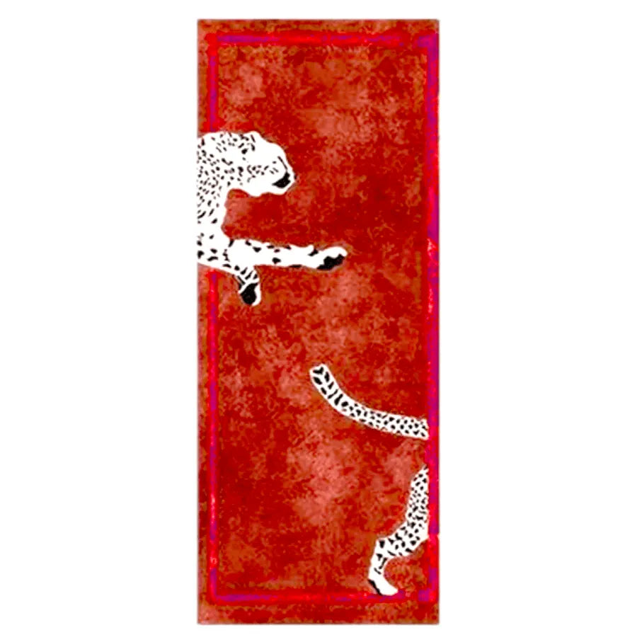 The Walking Wild Cat Leopard on Silk Road hand-tufted wool rug in red features a striking leopard design set against a rich red backdrop. Its bold pattern and plush wool texture add an exotic, luxurious touch to any space.