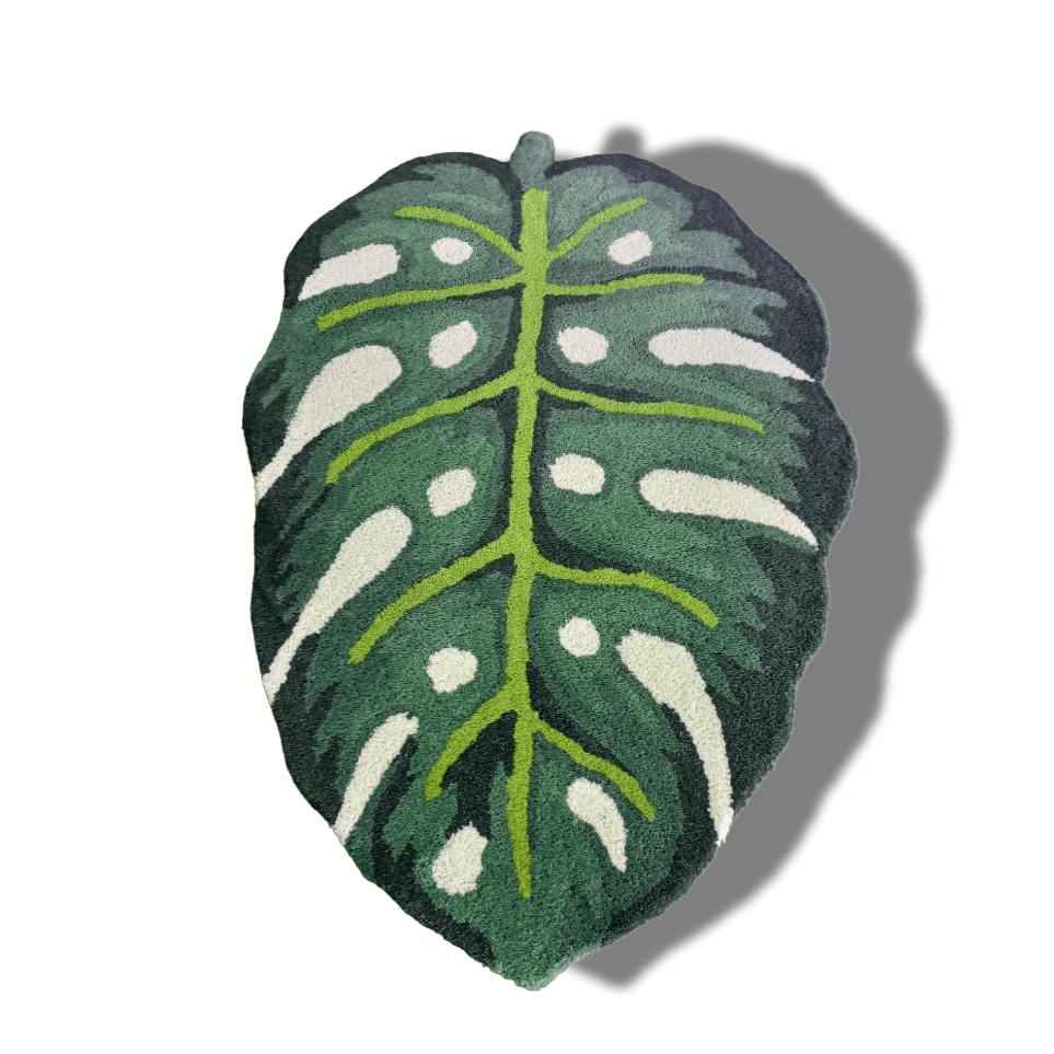 The Green Monstera Leaf Shaped accent hand-tufted wool rug features a detailed, vibrant monstera leaf design. Its unique shape and soft wool texture bring a fresh, tropical flair to any room or space.