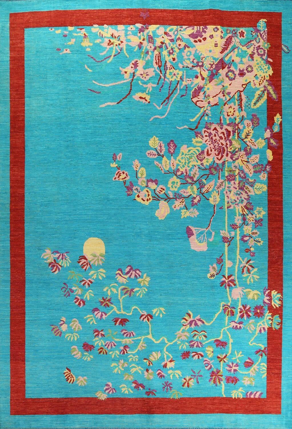 The Red Bordered Spring Floral in the Blue Sky wool hand-knotted area rug features vibrant floral patterns framed by a bold red border. Its intricate craftsmanship and lively design bring freshness and elegance to any space.Rug