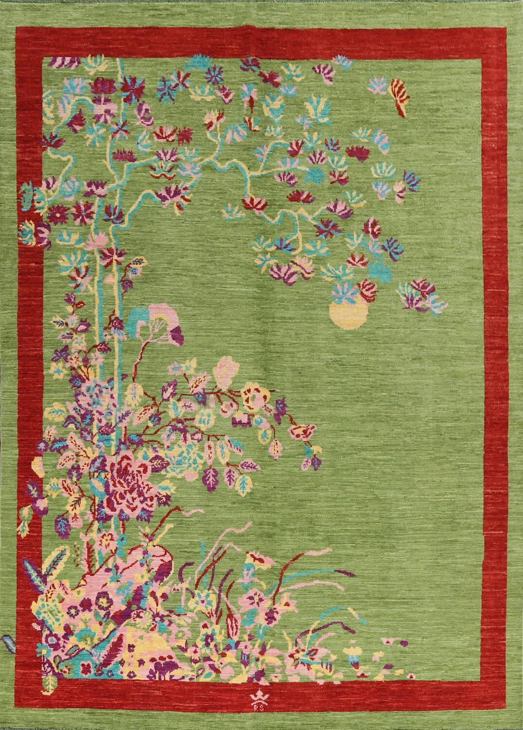 The Red Bordered Spring Floral in the green  Sky wool hand-knotted area rug features vibrant floral patterns framed by a bold red border. Its intricate craftsmanship and lively design bring freshness and elegance to any space.Rug