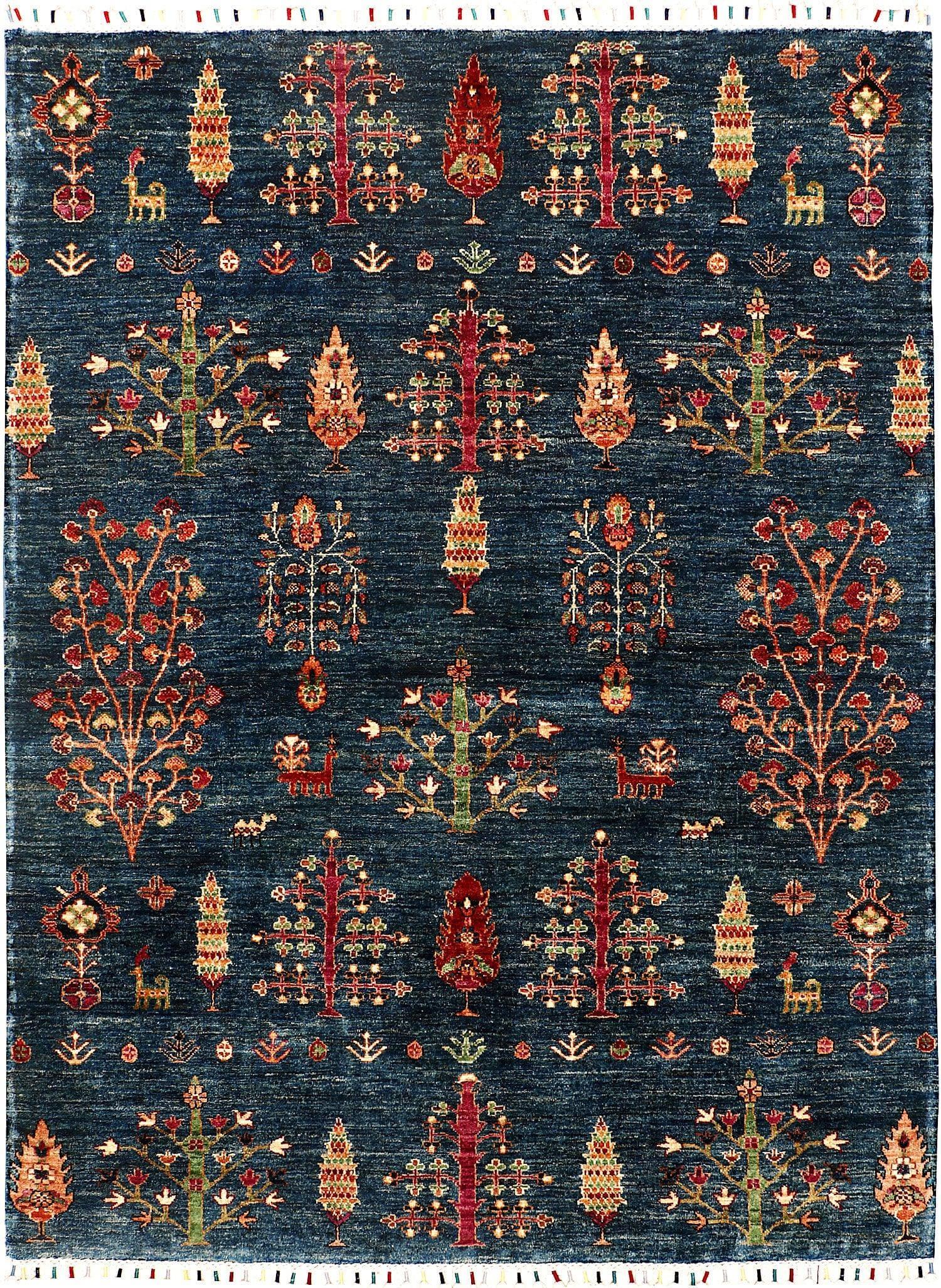 The Tibetan Trees of Life wool hand-knotted area rug features intricate tree motifs with vibrant, earthy tones. Its expert craftsmanship and luxurious wool texture create a timeless, elegant addition to any room. 